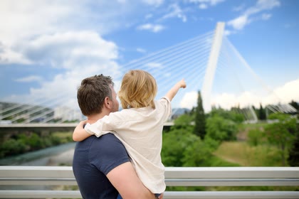 Parent and child overlooking the Millennium Bridge in Podgorica